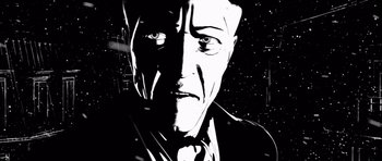 Movie still from “Renaissance” (2006), directed by Christian Volckman – A black - and - white photo of a man in a suit; Close Up shot, Low angle