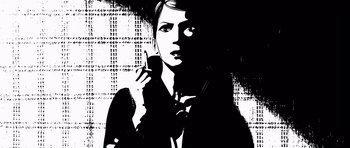 Movie still from “Renaissance” (2006), directed by Christian Volckman – A black and white image of a woman holding a cell phone; Close Up shot, Overhead angle