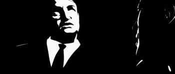 Movie still from “Renaissance” (2006), directed by Christian Volckman – A black and white image of a man in a suit and tie; Close Up shot, Low angle