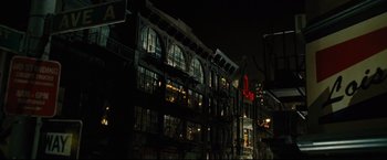 Movie still from “Rent” (2005), directed by Chris Columbus – A building that is lit up at night time; Extreme Wide shot, Low angle