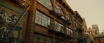 Movie still from “Rent” (2005), directed by Chris Columbus – A building with a fire escape on the side of the building; Extreme Wide shot, Low angle