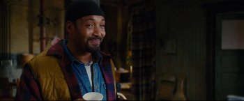 Movie still from “Rent” (2005), directed by Chris Columbus – A man holding a coffee cup in his right hand; Close Up shot, Over the shoulder angle
