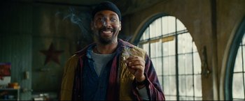 Movie still from “Rent” (2005), directed by Chris Columbus – A man smoking a cigarette while wearing a hat; Close Up shot, Low angle