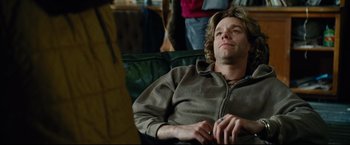 Movie still from “Rent” (2005), directed by Chris Columbus – A man sitting on a couch with his eyes wide open; Close Up shot, Over the shoulder angle