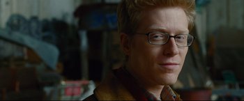 Movie still from “Rent” (2005), directed by Chris Columbus – A person wearing glasses; Close Up shot, Over the shoulder angle