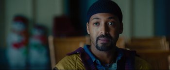 Movie still from “Rent” (2005), directed by Chris Columbus – A person wearing a hat; Close Up shot, Over the shoulder angle