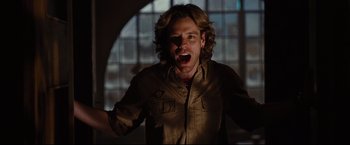 Movie still from “Rent” (2005), directed by Chris Columbus – A man with long blonde hair is screaming; Close Up shot, Low angle