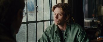 Movie still from “Rent” (2005), directed by Chris Columbus – A man in a green shirt looking out of a window; Close Up shot, Over the shoulder angle