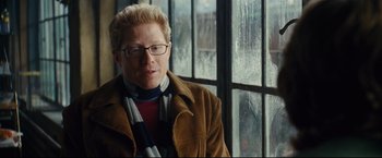 Movie still from “Rent” (2005), directed by Chris Columbus – A man in a brown jacket and a striped scarf; Close Up shot, Over the shoulder angle