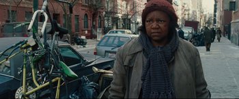 Movie still from “Rent” (2005), directed by Chris Columbus – A woman standing on the side of the street; Close Up shot, Over the shoulder angle