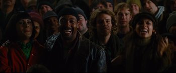 Movie still from “Rent” (2005), directed by Chris Columbus – A group of men standing next to each other in a room; Close Up shot, Over the shoulder angle
