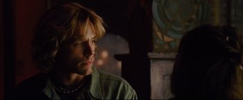 Movie still from “Rent” (2005), directed by Chris Columbus – A man with long blonde hair looking to his left; Close Up shot, Over the shoulder angle