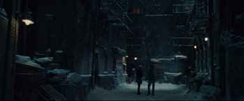 Movie still from “Rent” (2005), directed by Chris Columbus – Two people walking down a street in the snow; Wide shot, High angle