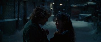 Movie still from “Rent” (2005), directed by Chris Columbus – A man and a woman holding hands in the rain; Medium shot, Over the shoulder angle