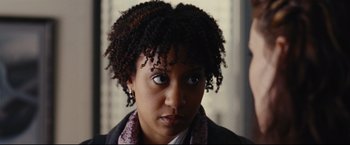 Movie still from “Rent” (2005), directed by Chris Columbus – A person wearing a jacket and a scarf; Close Up shot, Over the shoulder angle