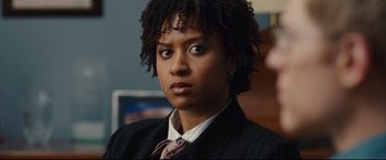 Movie still from “Rent” (2005), directed by Chris Columbus – A person wearing a suit and tie; Close Up shot, Over the shoulder angle