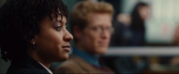 Movie still from “Rent” (2005), directed by Chris Columbus – Two people sitting in front of each other in a room; Close Up shot, Over the shoulder angle