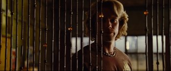 Movie still from “Rent” (2005), directed by Chris Columbus – A man standing in front of a wooden fence; Close Up shot, Over the shoulder angle