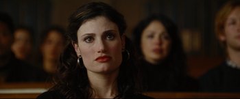 Movie still from “Rent” (2005), directed by Chris Columbus – A woman with red lipstick stares into the distance; Close Up shot, Over the shoulder angle