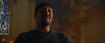 Movie still from “Rent” (2005), directed by Chris Columbus – A person wearing a hat; Close Up shot, Low angle