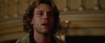 Movie still from “Rent” (2005), directed by Chris Columbus – A person with long blonde hair; Close Up shot, Over the shoulder angle