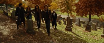 Movie still from “Rent” (2005), directed by Chris Columbus – A group of people walking through a cemetery; Wide shot, High angle