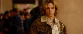 Movie still from “Rent” (2005), directed by Chris Columbus – A person wearing a jacket; Close Up shot, Over the shoulder angle