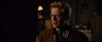 Movie still from “Rent” (2005), directed by Chris Columbus – A man with blonde spiky hair wearing glasses; Close Up shot, Over the shoulder angle