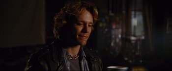 Movie still from “Rent” (2005), directed by Chris Columbus – A person wearing a leather jacket; Close Up shot, Over the shoulder angle