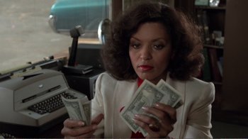 Movie still from “Repo Man” (1984), directed by Alex Cox – A woman holding a stack of money in her hands; Close Up shot, Low angle