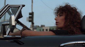 Movie still from “Repo Man” (1984), directed by Alex Cox – A woman sitting in the passenger seat of a car; Close Up shot, Low angle