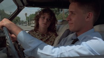 Movie still from “Repo Man” (1984), directed by Alex Cox – A man and a woman sitting in the back seat of a car; Close Up shot, Over the shoulder angle