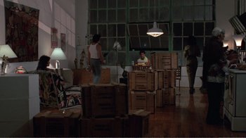 Movie still from “Repo Man” (1984), directed by Alex Cox – A room filled with lots of wooden boxes; Wide shot, High angle