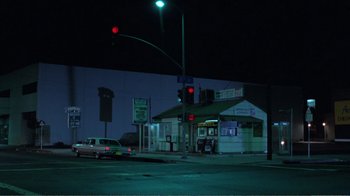 Movie still from “Repo Man” (1984), directed by Alex Cox – A car parked on the side of the road at night; Extreme Wide shot, Low angle