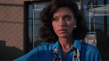 Movie still from “Repo Man” (1984), directed by Alex Cox – A person wearing a blue shirt; Close Up shot, Low angle