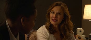 Movie still from “13 Reasons Why” (2017), created by Brian Yorkey – A woman sitting next to another woman in front of a wall; Close Up shot, Over the shoulder angle