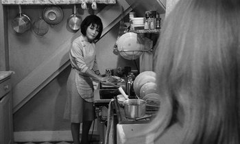 Movie still from “Repulsion” (1965), directed by Roman Polanski – A black and white photo of a woman in a kitchen; Medium shot, High angle