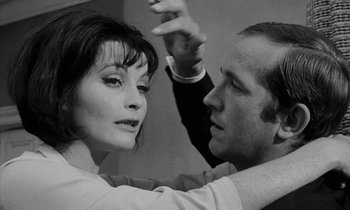 Movie still from “Repulsion” (1965), directed by Roman Polanski – A man and a woman dancing together in a black and white photo; Close Up shot, Low angle