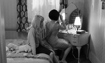 Movie still from “Repulsion” (1965), directed by Roman Polanski – Two women sitting in front of a vanity mirror; Medium shot, High angle