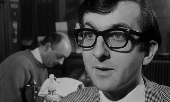Movie still from “Repulsion” (1965), directed by Roman Polanski – A black and white photo of a man wearing glasses; Close Up shot, Low angle