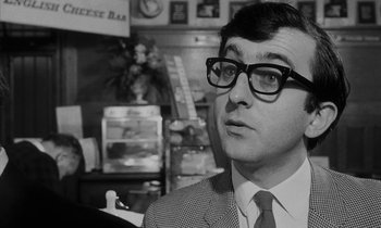 Movie still from “Repulsion” (1965), directed by Roman Polanski – A man wearing glasses and a suit and tie; Close Up shot, Over the shoulder angle
