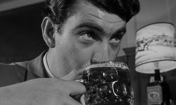 Movie still from “Repulsion” (1965), directed by Roman Polanski – A black and white photo of a man drinking a glass of beer; Close Up shot, Low angle