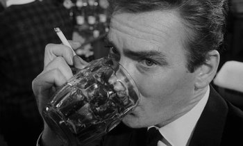 Movie still from “Repulsion” (1965), directed by Roman Polanski – A black and white photo of a man drinking from a glass; Close Up shot, Low angle