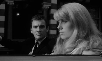 Movie still from “Repulsion” (1965), directed by Roman Polanski – A man and a woman sitting next to each other in front of a mirror; Close Up shot, Low angle