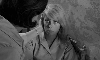 Movie still from “Repulsion” (1965), directed by Roman Polanski – A black - and - white photo of a woman looking at a woman's face; Close Up shot, Over the shoulder angle
