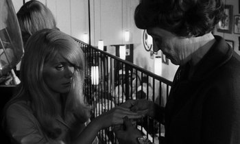Movie still from “Repulsion” (1965), directed by Roman Polanski – A woman is giving another woman something in her hand; Close Up shot, Over the shoulder angle