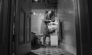 Movie still from “Repulsion” (1965), directed by Roman Polanski – A woman standing in a bathroom next to a sink; Wide shot, High angle