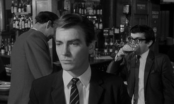 Movie still from “Repulsion” (1965), directed by Roman Polanski – Black and white photograph of a man wearing a suit and tie; Close Up shot, Over the shoulder angle