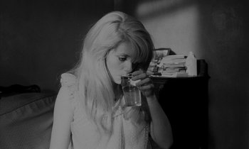 Movie still from “Repulsion” (1965), directed by Roman Polanski – A woman drinking a glass of water from a glass; Close Up shot, High angle