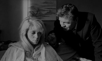 Movie still from “Repulsion” (1965), directed by Roman Polanski – A man and a woman are looking at each other in a room; Close Up shot, Over the shoulder angle